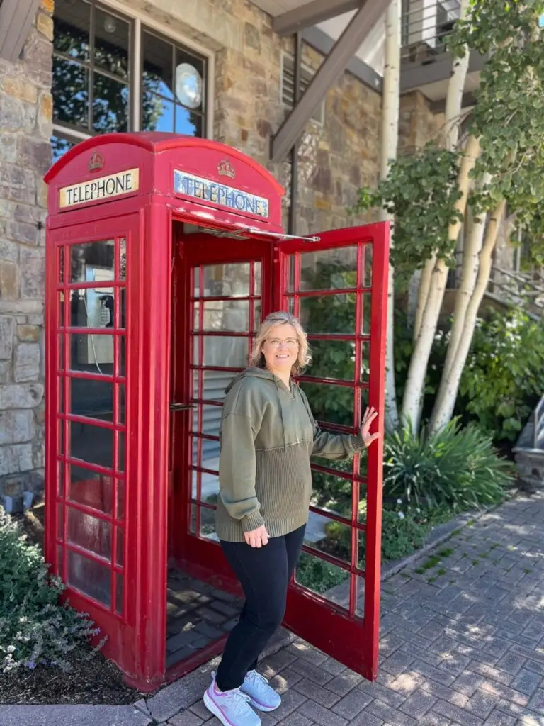 Person in red telephone booth.