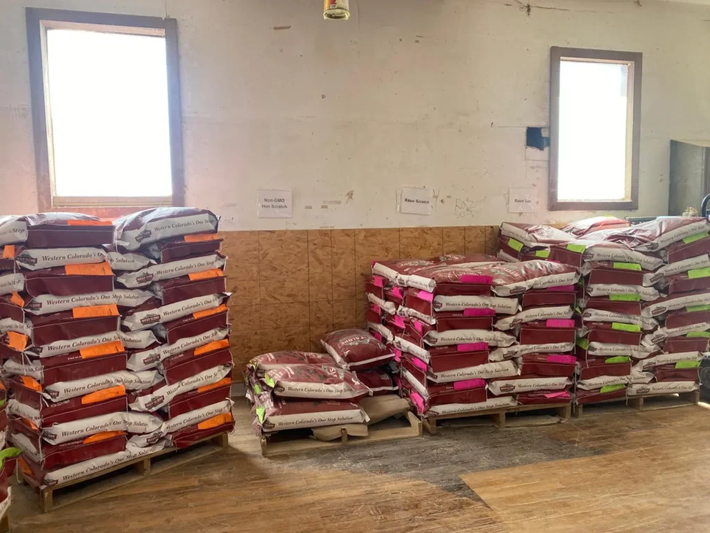 Home 6 Stacks of premium non-GMO and locally sourced livestock feed inside our feed store Delta CO.
